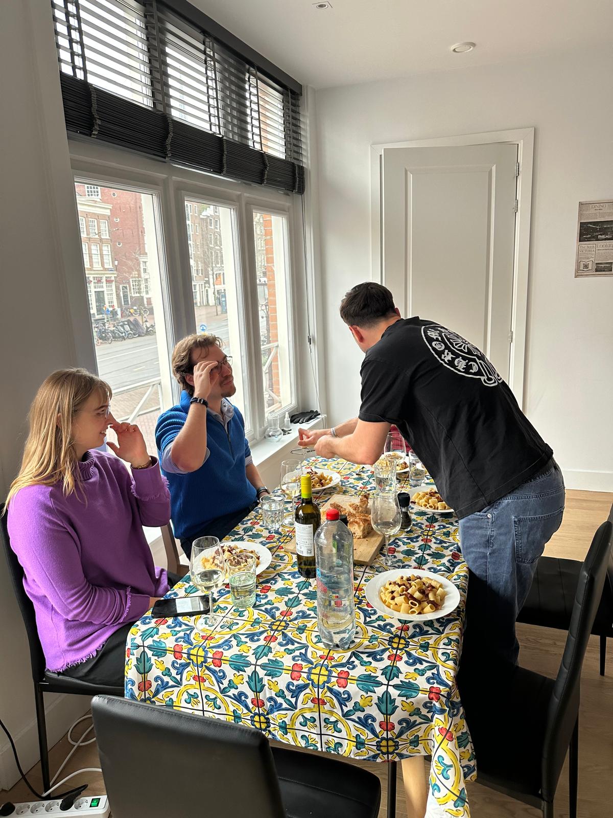 Friends enjoying a real dinner at The Dinner Club in Amsterdam